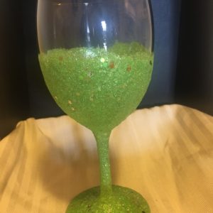 A Hand crafted Sparkle Wine Glass-Made by order filled with green glitter.