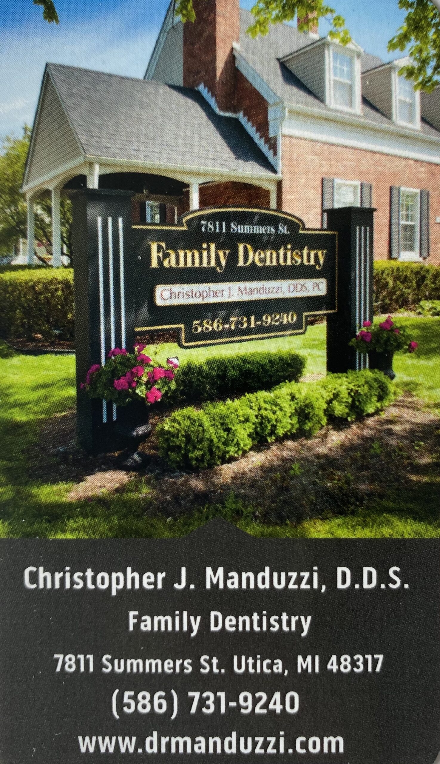 2021 manduzzi ad A sign for dr j manduzi's family dentistry.