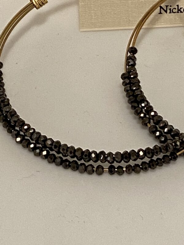 A pair of Chocolate Stones 2 3/4" Triple Hoop Earrings with black crystals on them.