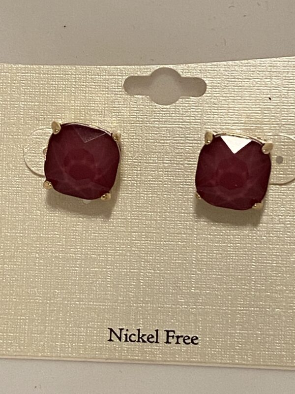 A pair of Puce with Gold Setting 1/2" stud earrings on a card.