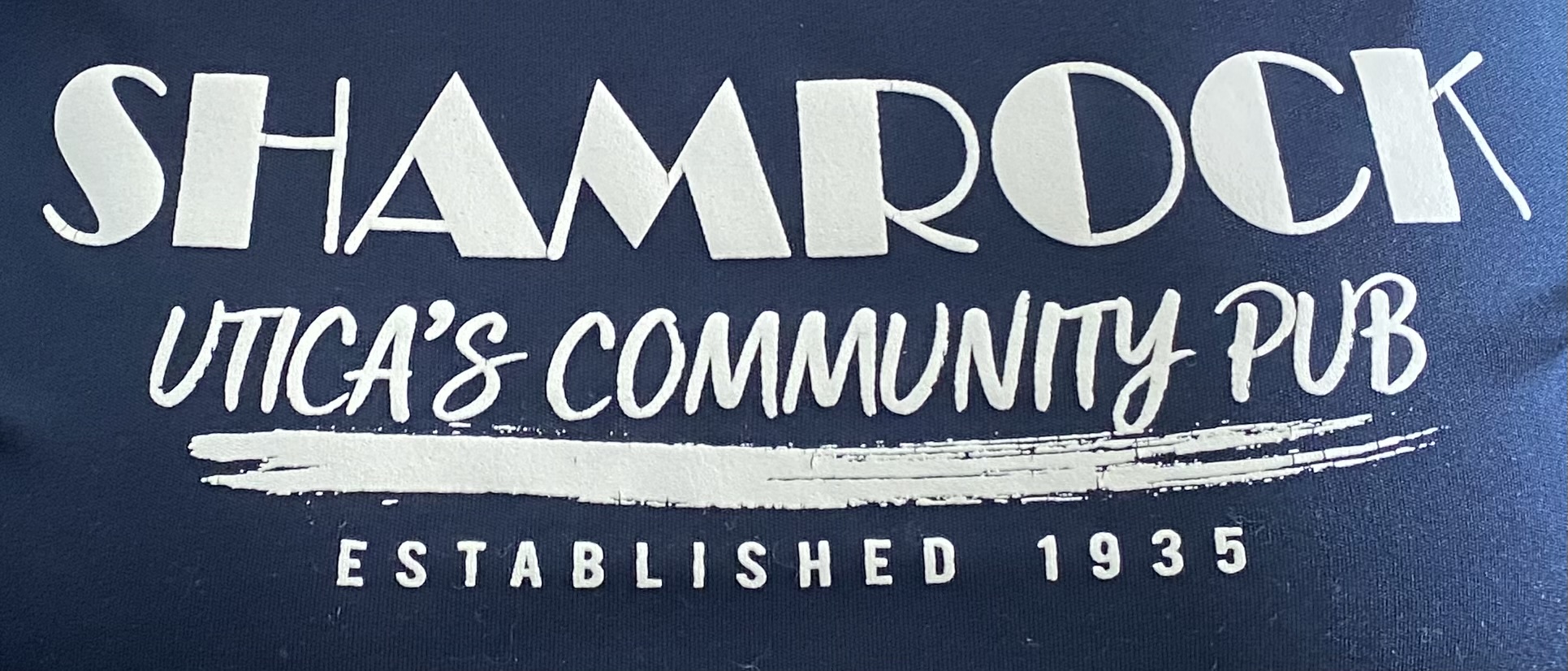 shamrock pub logo A t-shirt with the words shamrock's community pub on it.