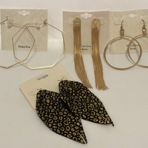 A variety of '23 Christmas In July Brass with a little Animal hoop earrings on a white background.