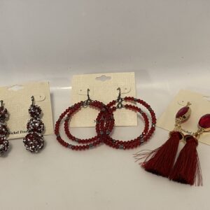 A pair of '23 Christmas In July Red Glitter Set earrings with red beads and tassels.