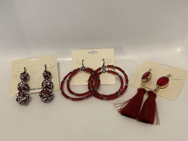 A pair of '23 Christmas In July Red Glitter Set earrings with red beads and tassels.