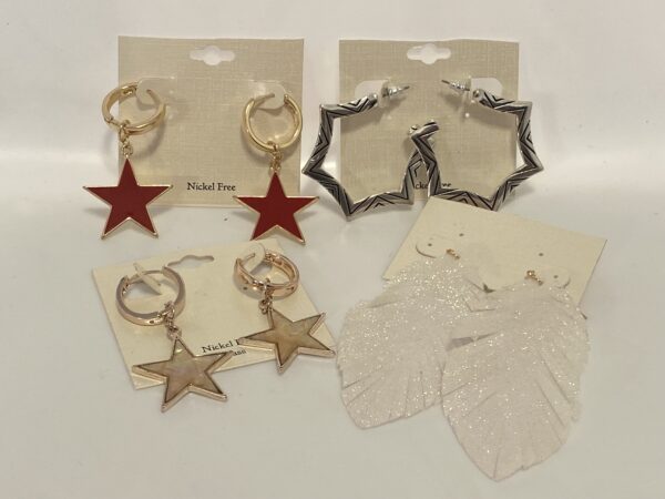 A variety of '23 Christmas In July Brushed Gold & Abstract Animal shaped earrings on a white background.